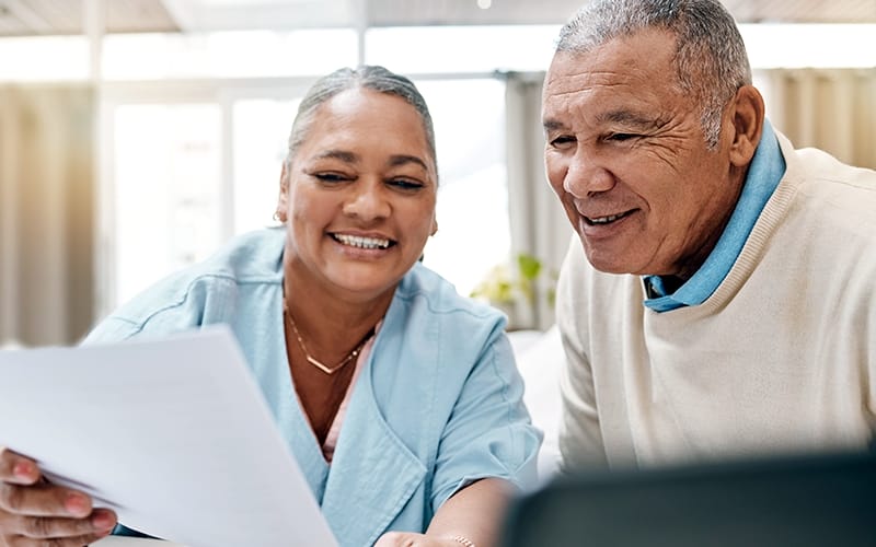 senior black couple with paperwork